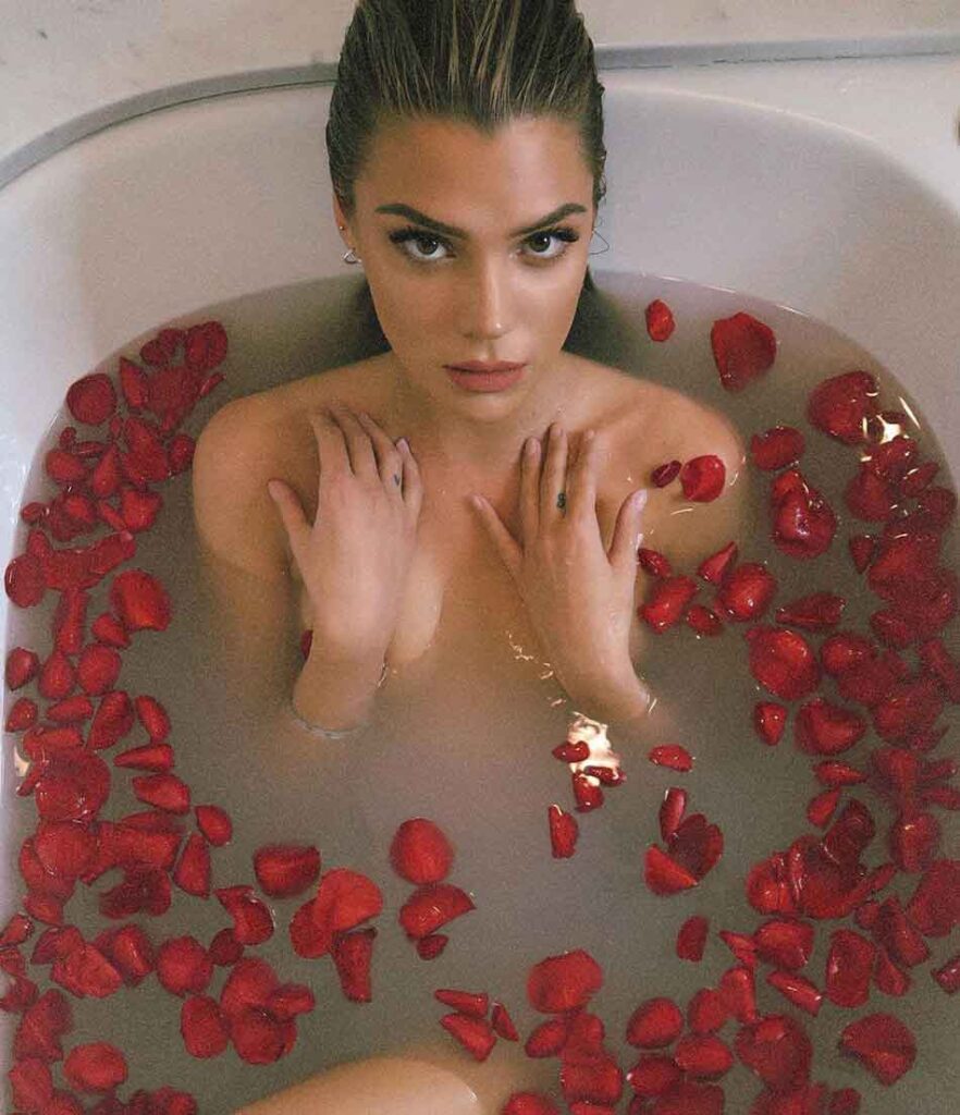 a beautiful mistress in a bath full of rose petals