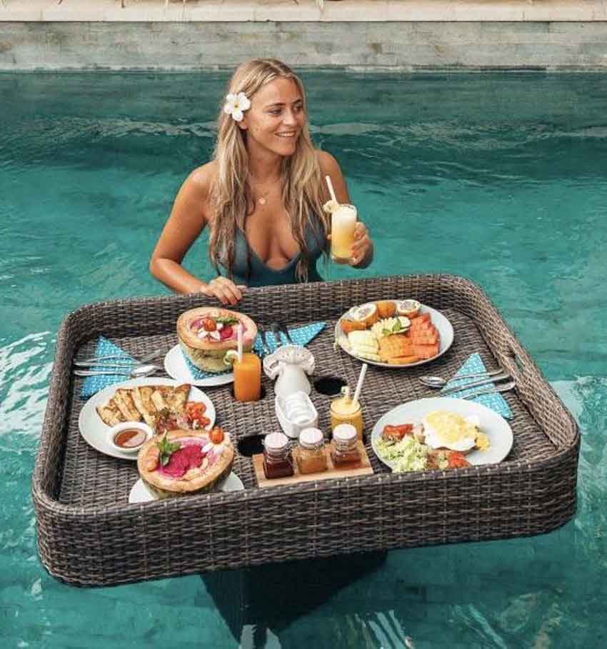 a mistress in the pool receivng breakfast floating