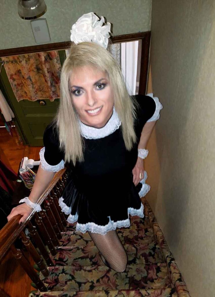 a sissy maid posing on stairs