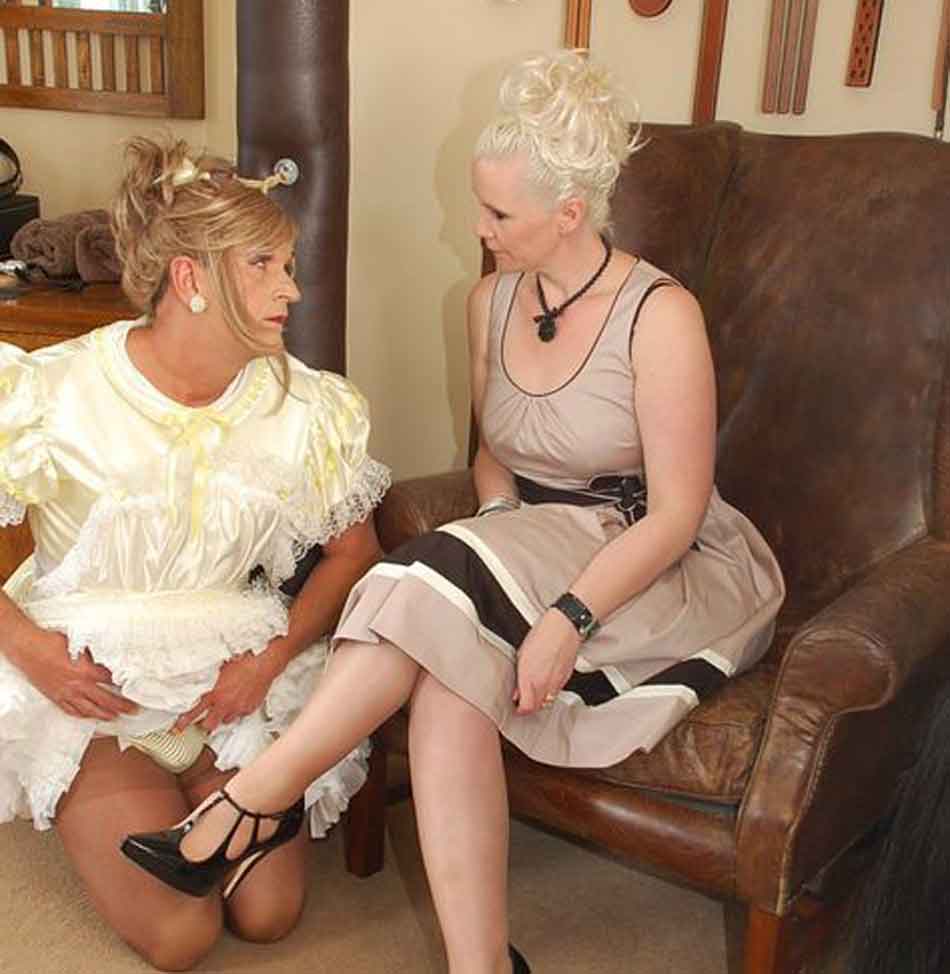 a sissy maid kneels next to her mistress