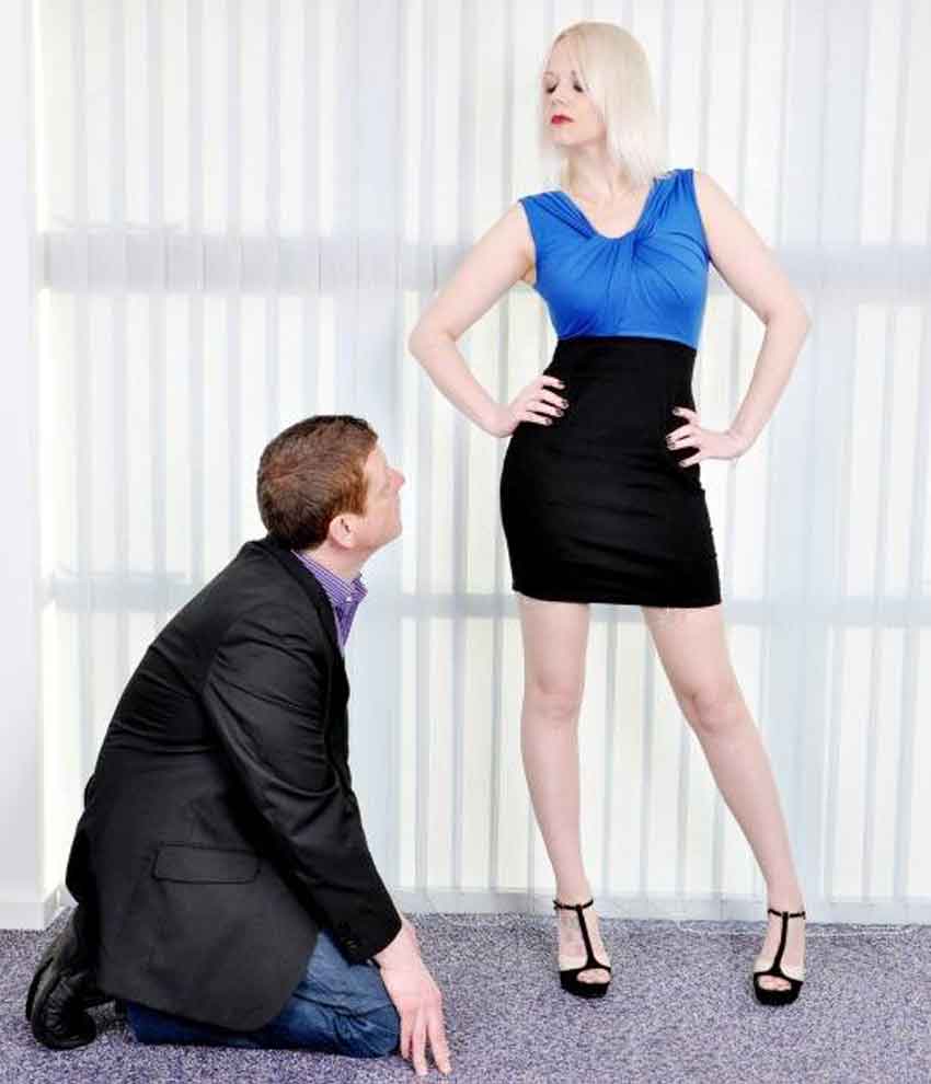 a female dominant looks down on her sub