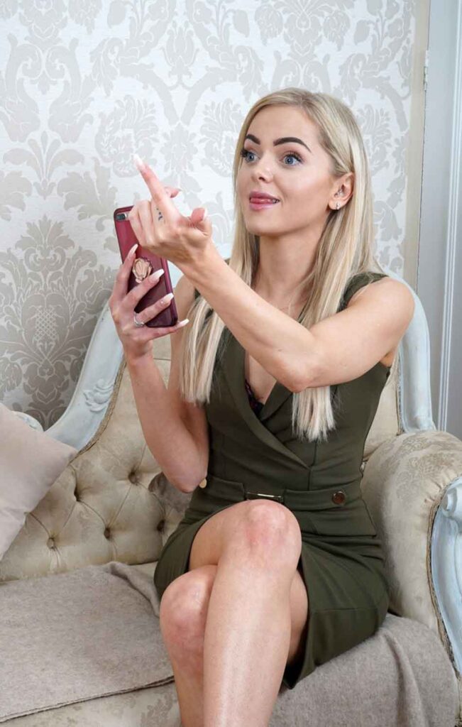 a mistress beckons a submissive with smartphone
