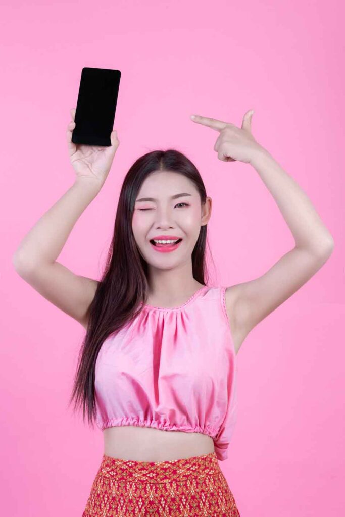 a female dominant looks happy with her smartphone