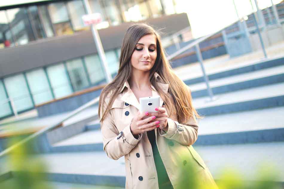 a female dominant looks at her smartphone