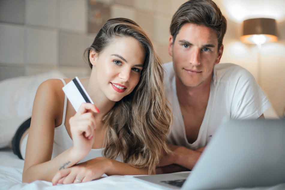 a findom couple with laptop and credit card