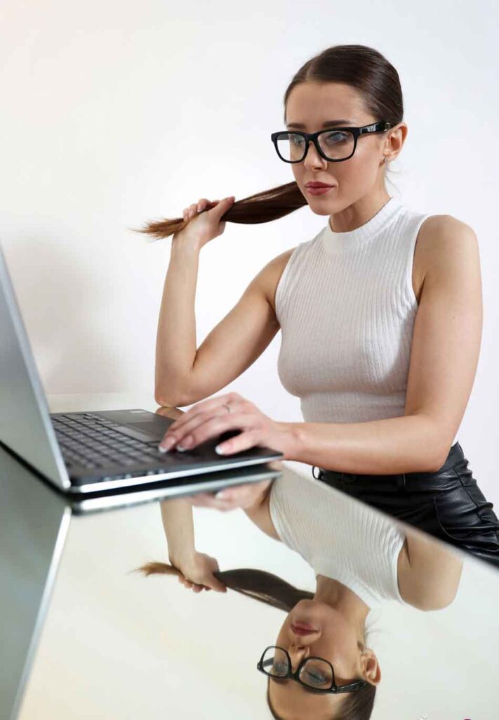 a brunette mistress at her laptop