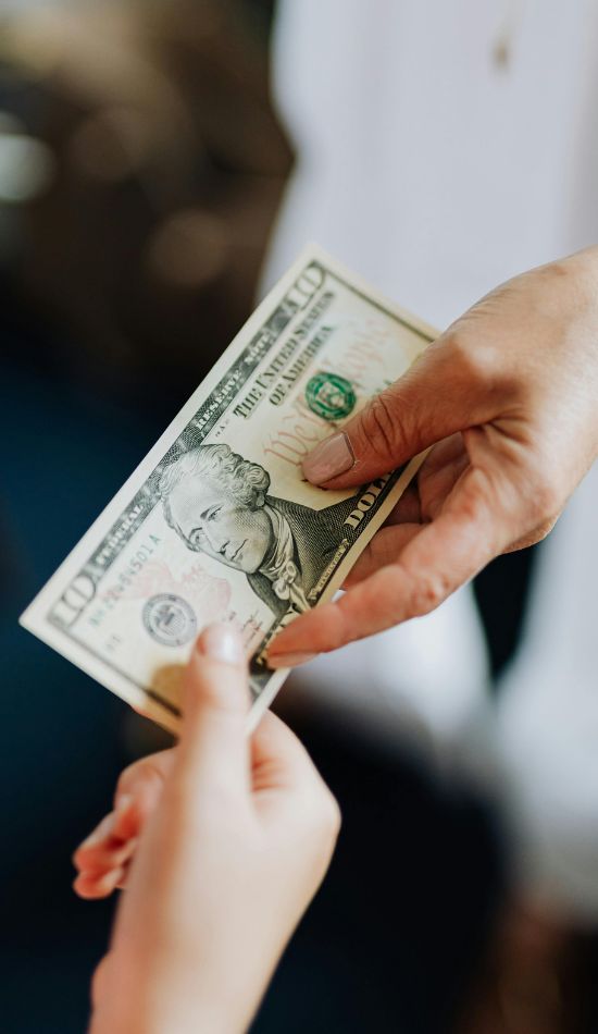 a man handing cash to a woman