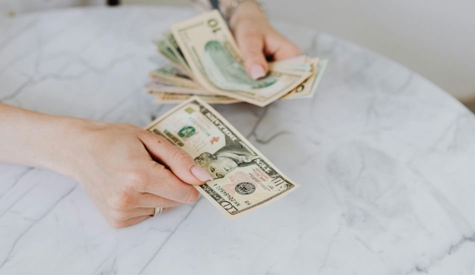 dollars being counted by hand